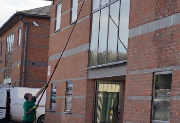 Hampshire professional member of staff doing ladderless office window cleaning